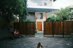 a dog laying on the ground in front of a house